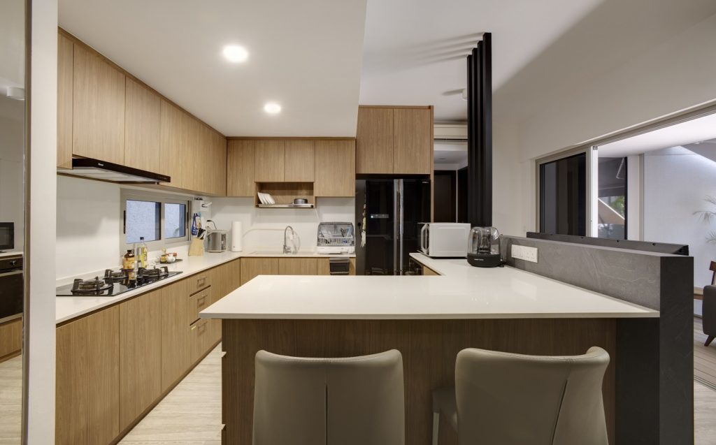 open-concept kitchen and island in wood and black hues