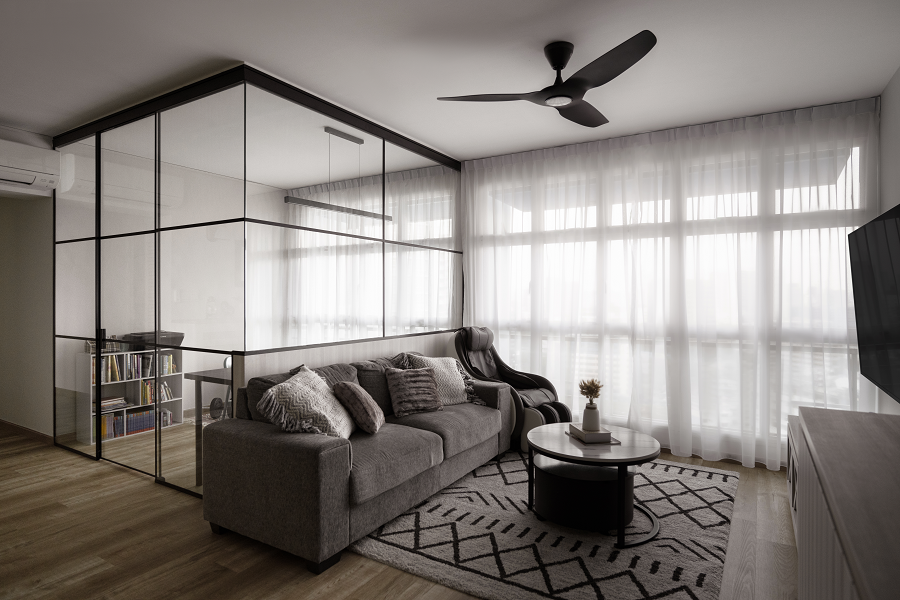 living room with glass partitioned room with black metal borders and grilles