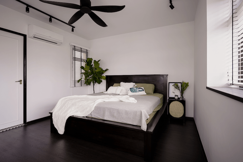 black and white bedroom with green plants